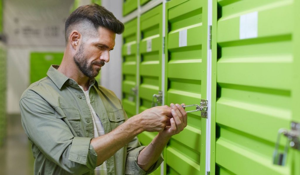 man securing his storage unit